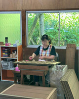Hand holding Earl of East Shinrin-Yoku incense package showing product branding and forest-inspired design