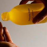 Shinrin-Yoku All Over Oil being applied to skin, showing lightweight texture