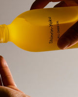 Shinrin-Yoku All Over Oil being applied to skin, showing lightweight texture