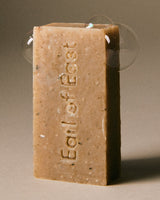 Close-up view of Earl of East Shinrin-Yoku Cleansing Soap Bar showing natural texture and earthy tones, inspired by forest bathing.
