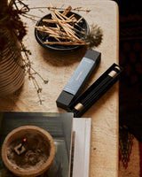Japanese incense sticks displayed in a serene home environment with natural elements