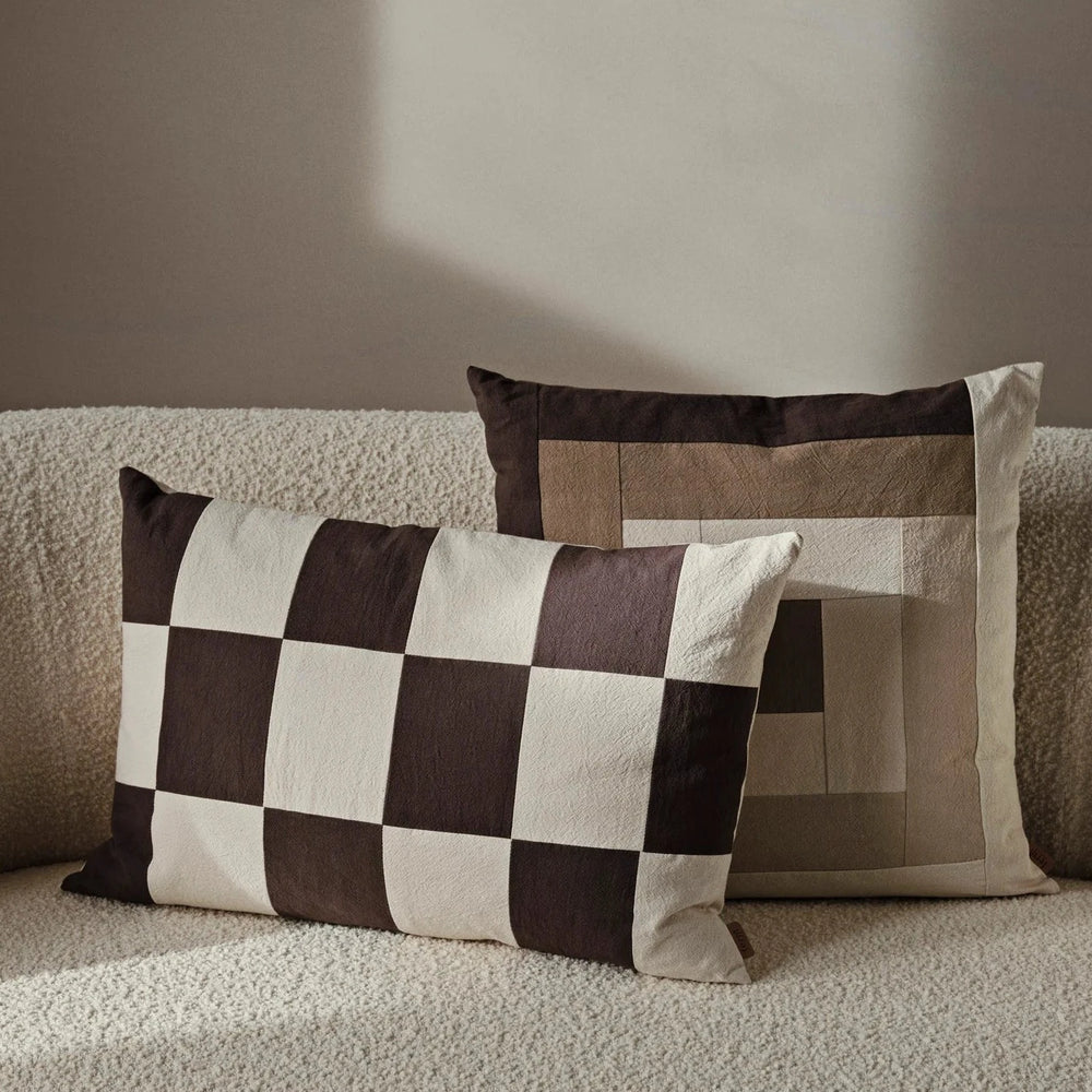 Fold Patchwork Cushion, Coffee by ferm LIVING, on a sofa with other cushions