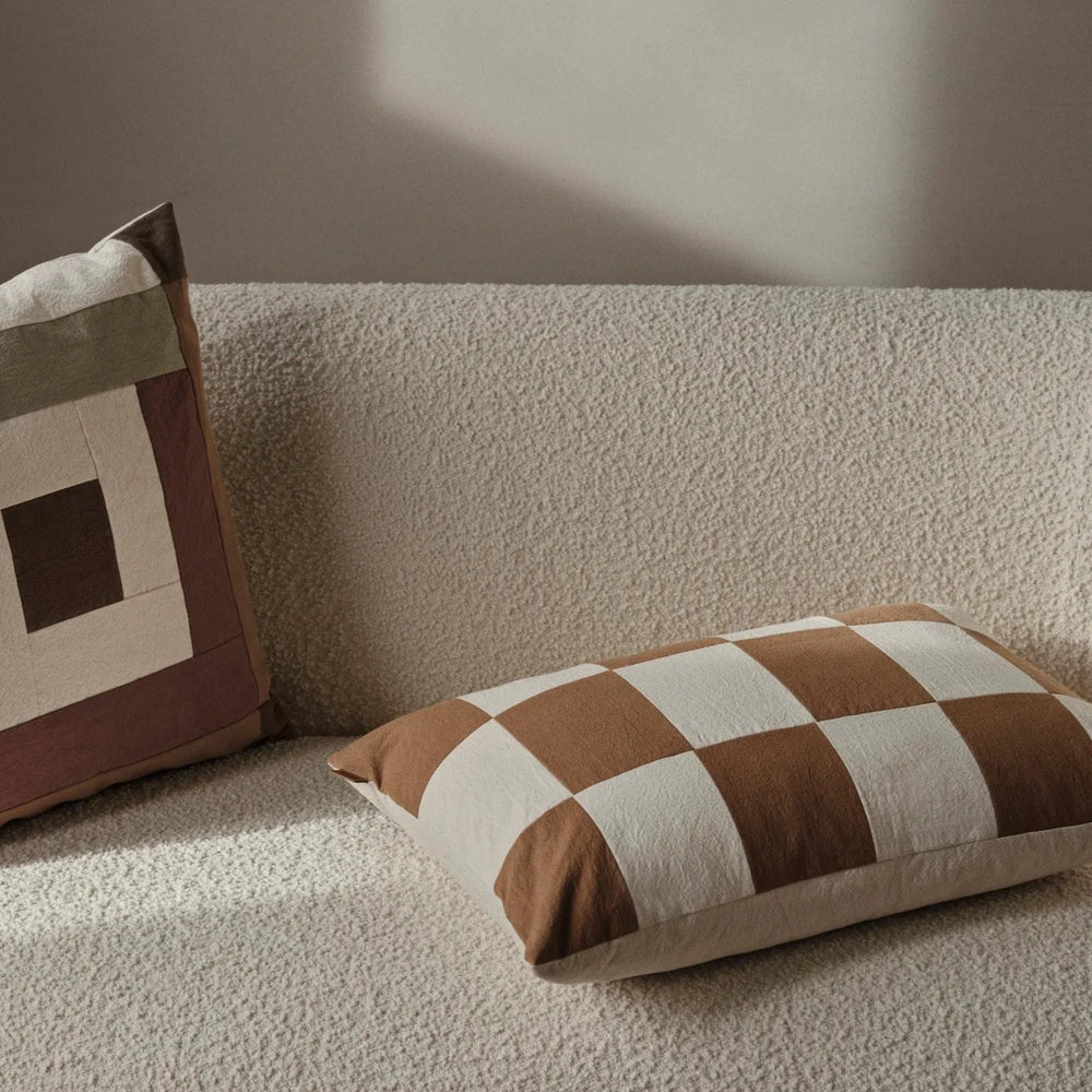 Fold Patchwork Cushion, Sugar Kelp by ferm LIVING, on a cream sofa