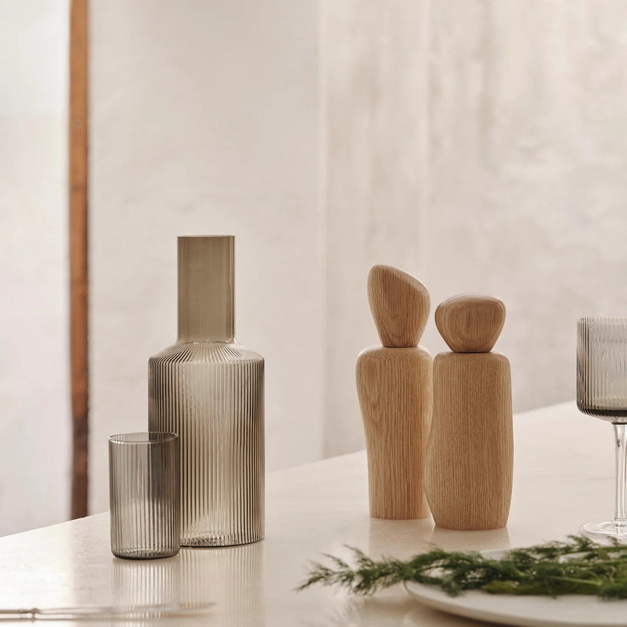 Cairn Salt & Pepper Grinder, Light Wood by ferm LIVING, on a kitchen counter with other grinders
