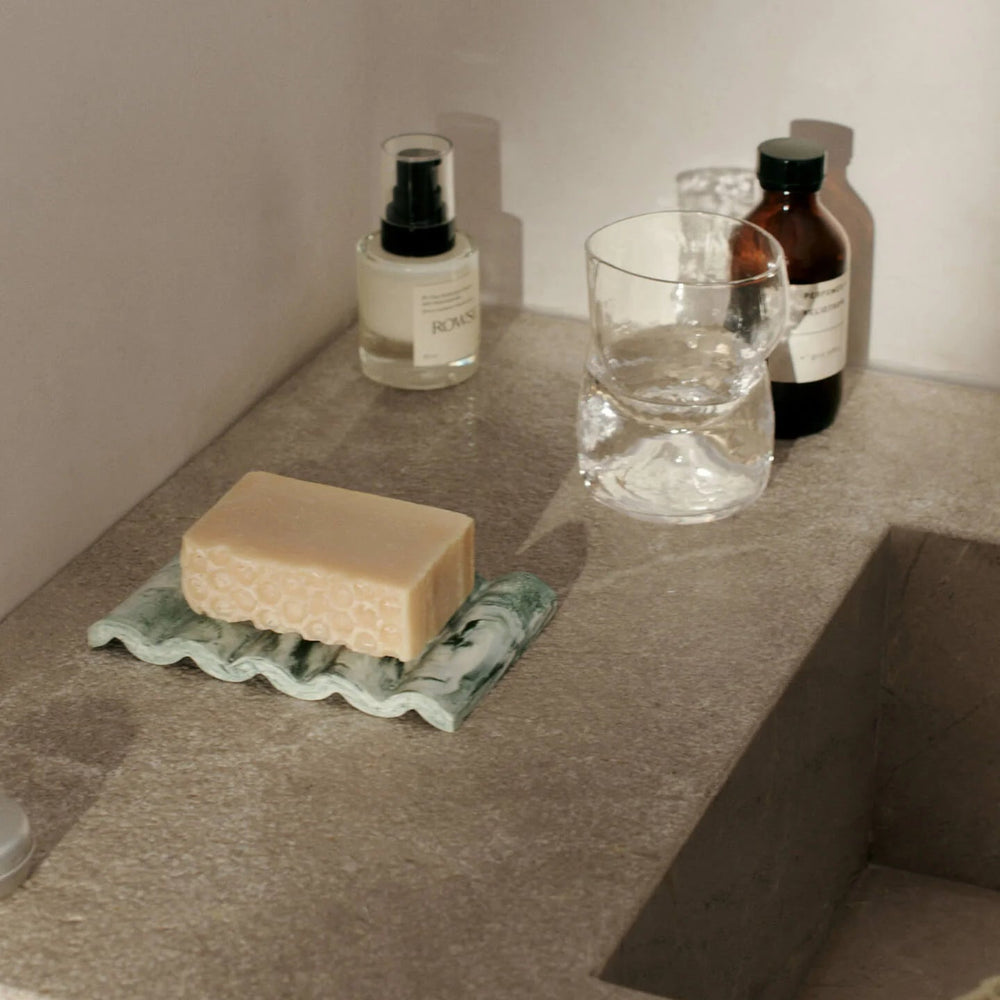 Mist Soap Dish, Emerald Off-White by ferm LIVING, on a bathroom counter