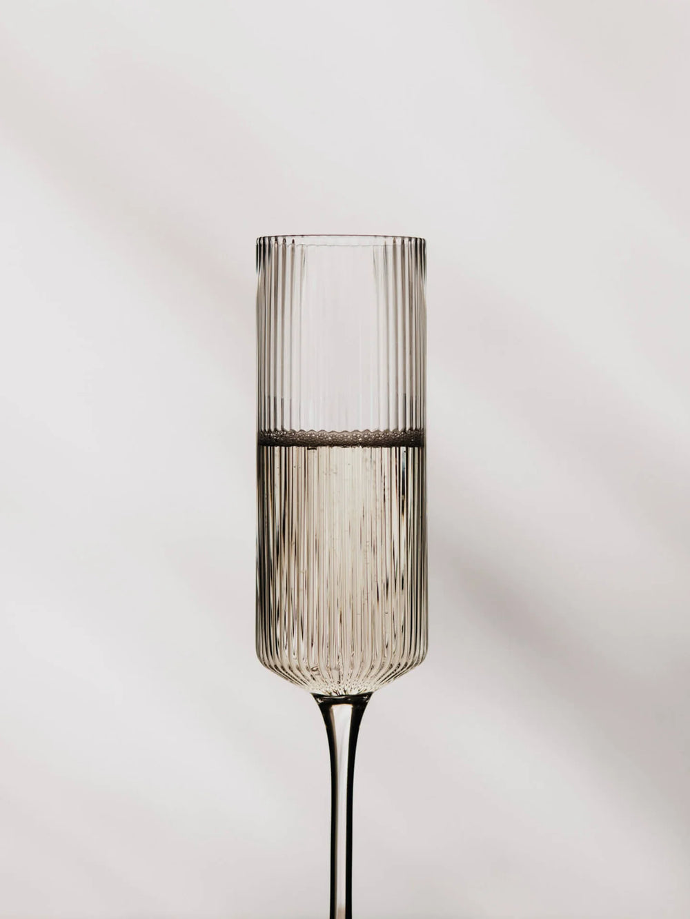 Ripple Champagne Flutes, Clear by ferm LIVING, filled with champagne