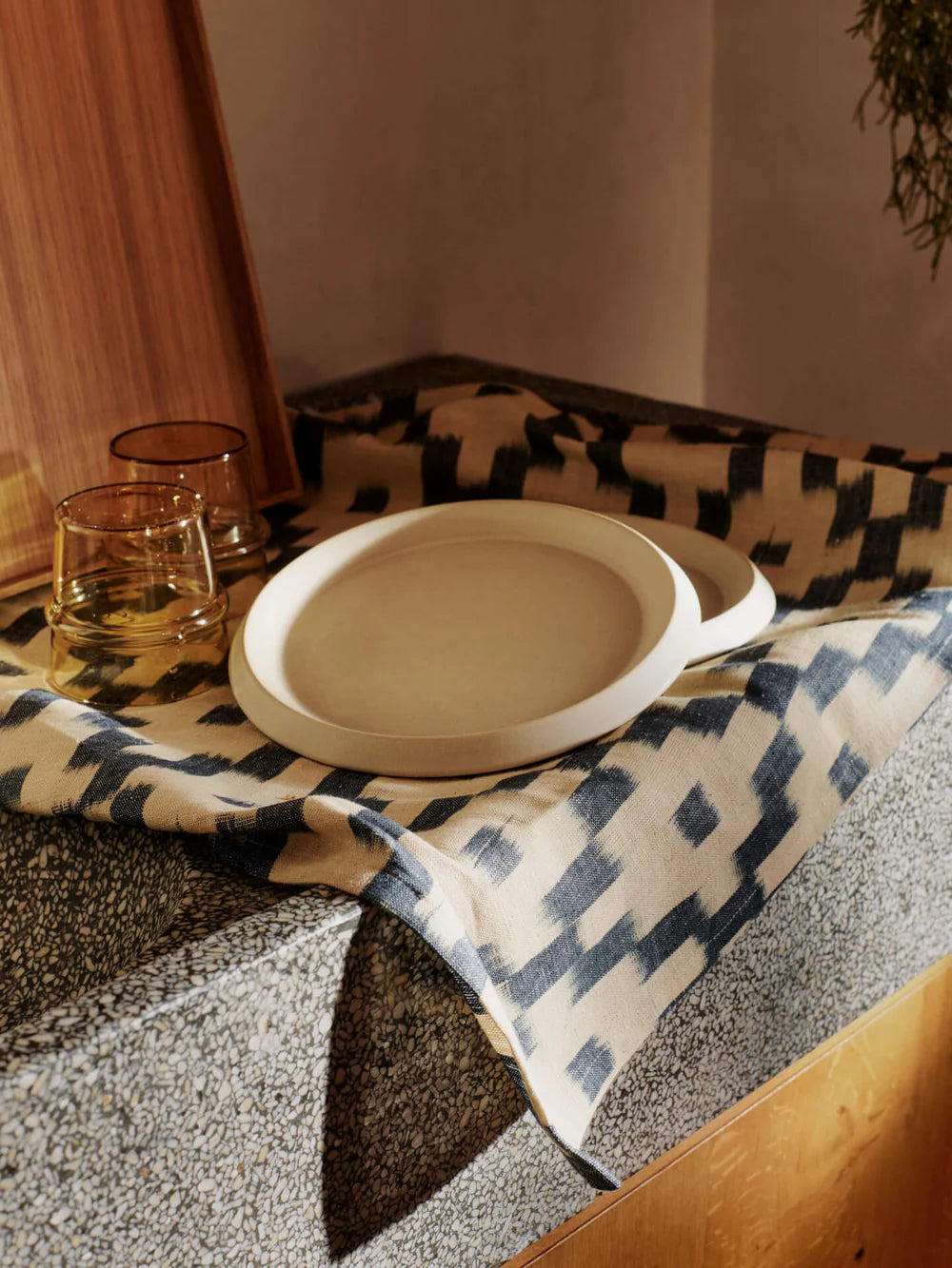 Ikat Tea Towel, Ink Blue/Off-White by ferm LIVING, lining a basket