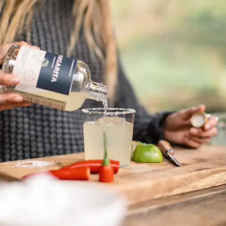 Non alcoholic Margarita Mixed by Pentire Drinks, being poured into a glass outdoors