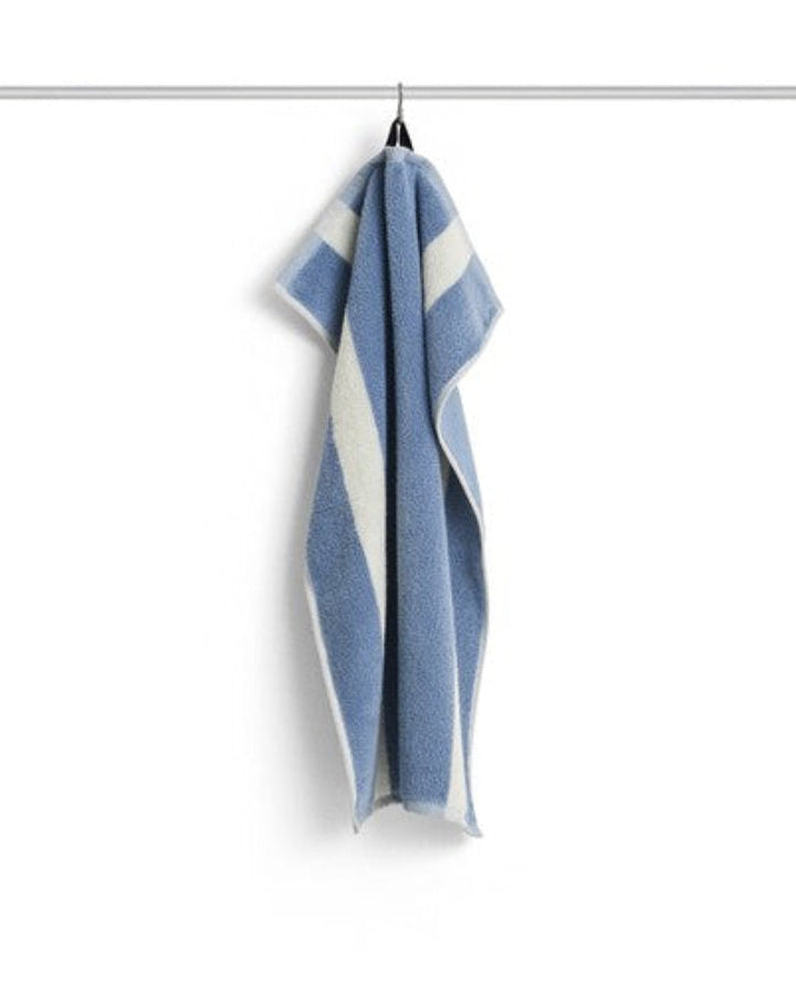 Stripe Hand Towel in Dusty Blue by HAY, hanging
