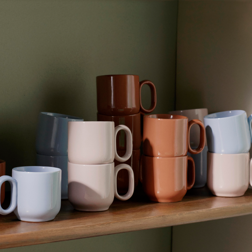 Barro Cup Set of Two, Light Blue by HAY, on a wooden shelf in a range of colours