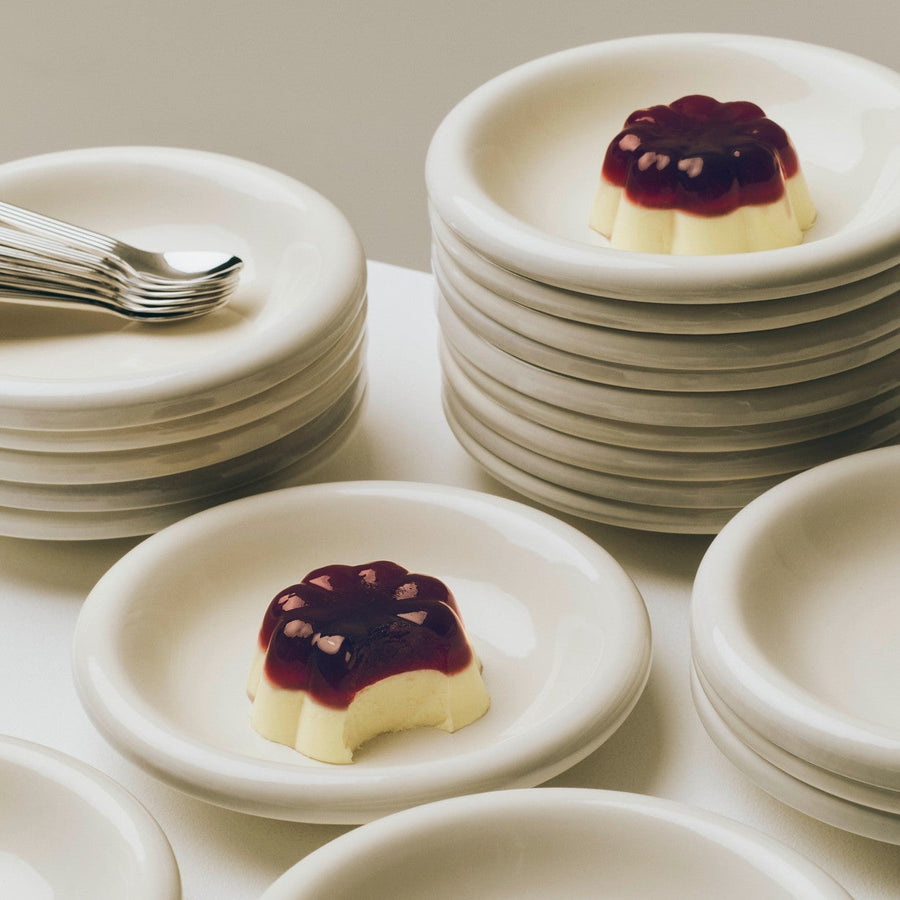 Barro Bowl, Set of Two, Off-White by HAY, stacked with dessert on a white table