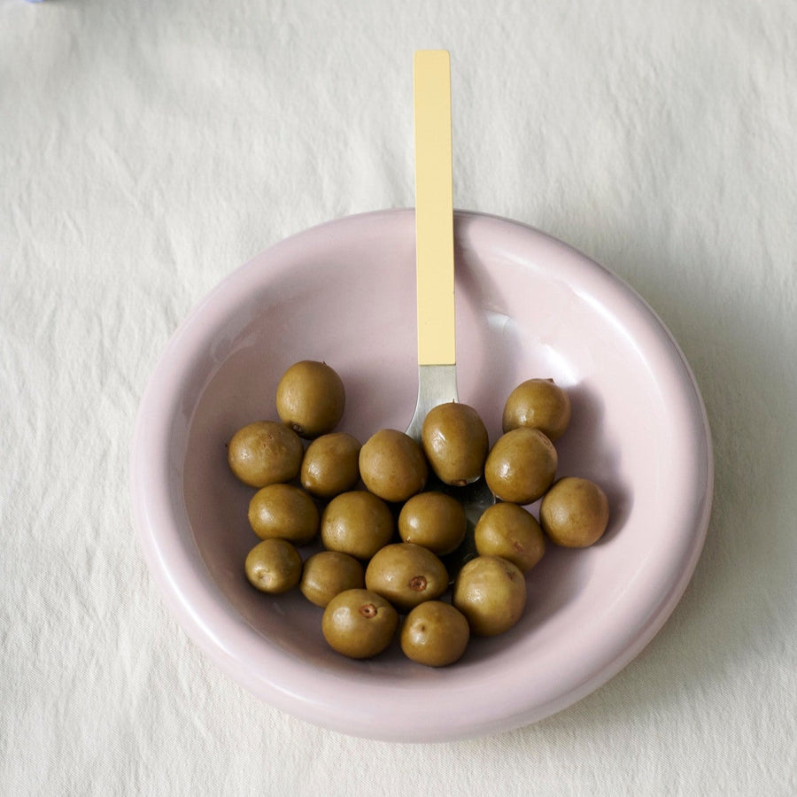 Barro Bowl, Set of Two, Pink by HAY, holding green olives on a fluffy rug