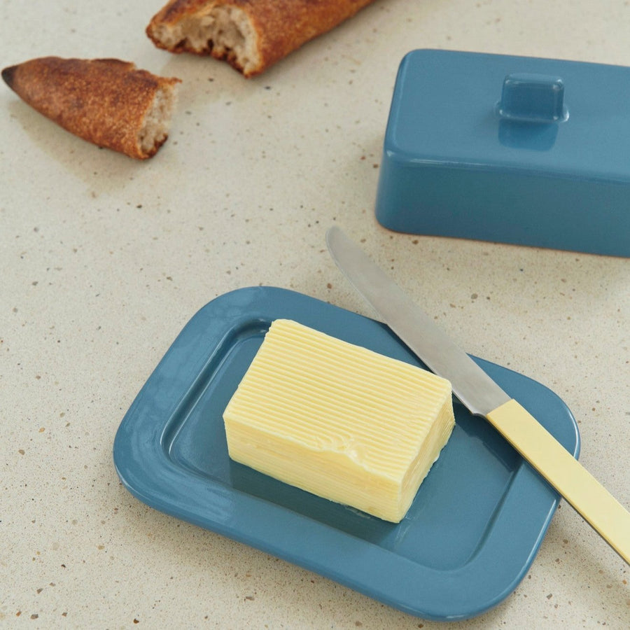 Barro Butter Dish, Dark Blue by HAY, holding butter with bread on a linen cloth