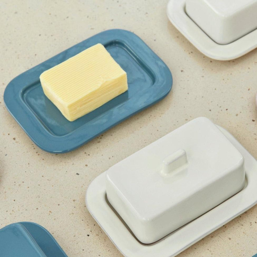 Barro Butter Dish, Off-White by HAY, holding butter beside other colourways