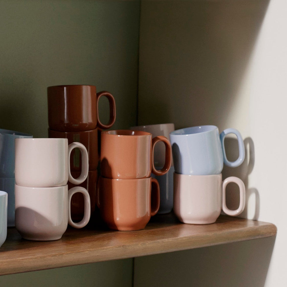 Barro Cup Set of Two, Pink by HAY, on a wooden shelf in a range of colours
