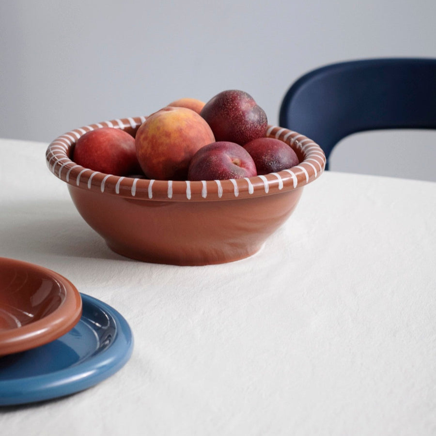 Barro Salad Bowl, Large, Natural With White Stripes by HAY, filled with plums on a white table