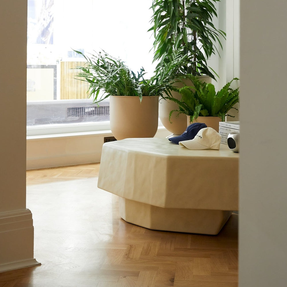 Staffa Coffee Table, Large, Ivory by ferm LIVING, in a living room with plants
