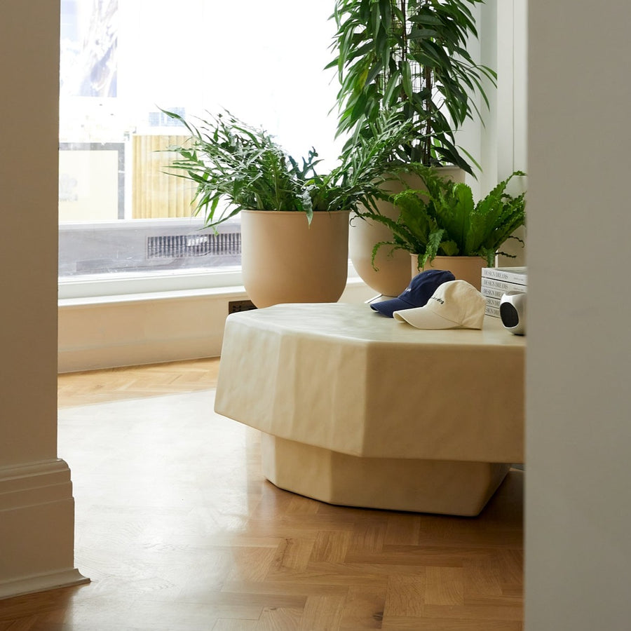Staffa Coffee Table, Large, Ivory by ferm LIVING, in a living room with plants
