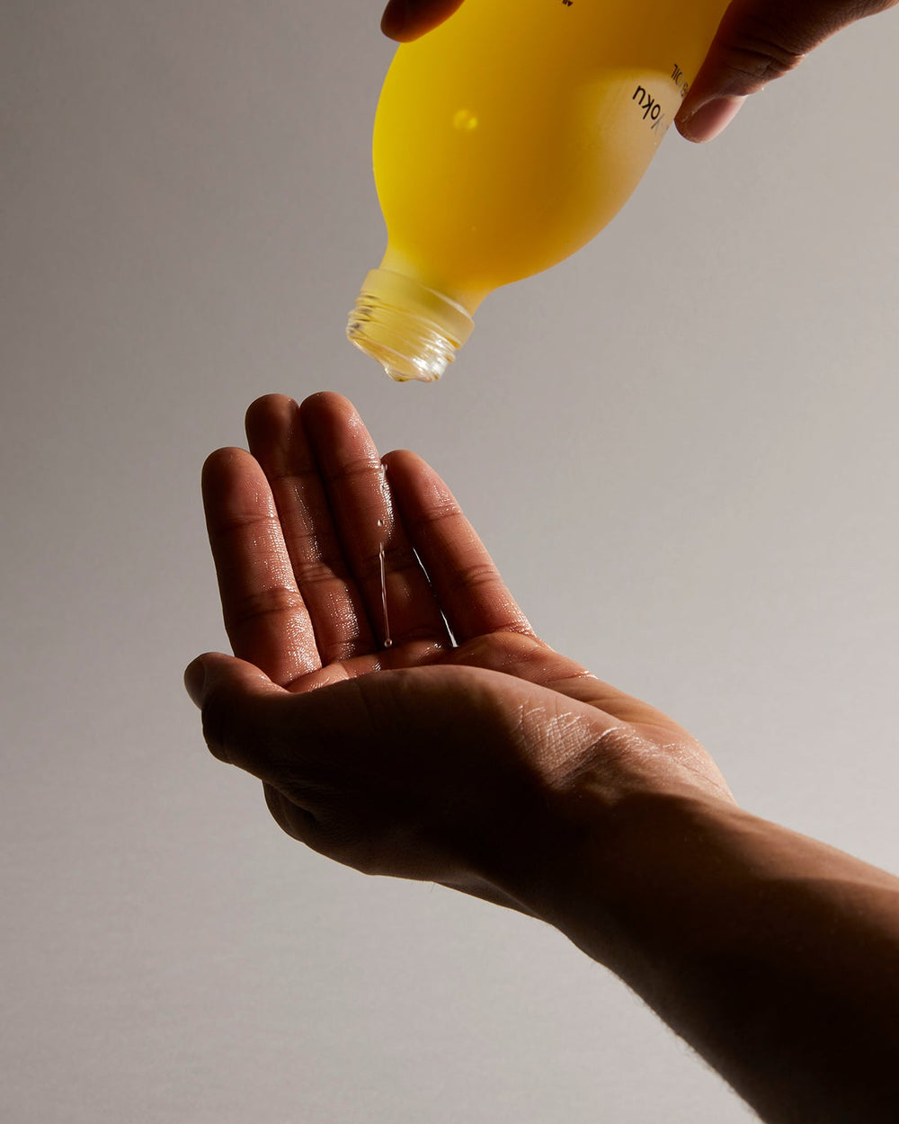 Staying In Bundle by Earl of East, oil being poured into a hand