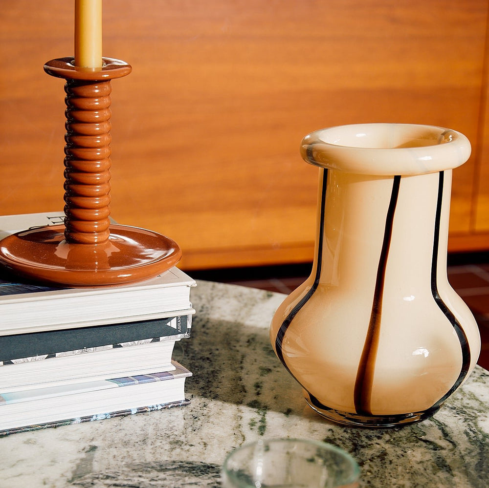 Riban Vase, Cream, Large by ferm LIVING, on a stone table with books