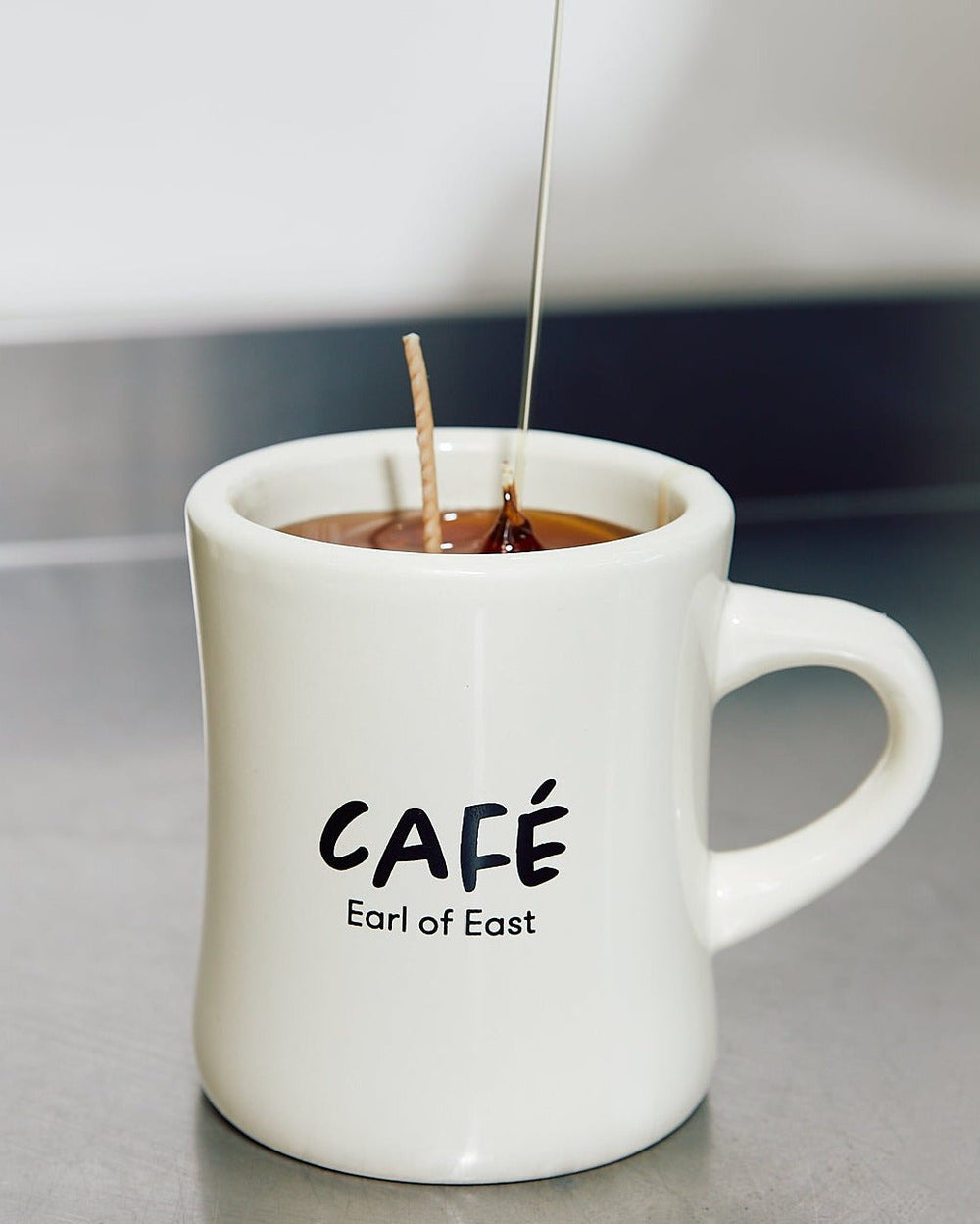 Americano Scented Candle in Mug, 300ml by Earl of East, lit, on a white background