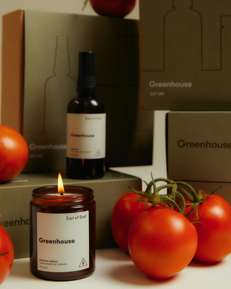 Greenhouse Duo Gift Set by Earl of East, lit beside fresh tomatoes