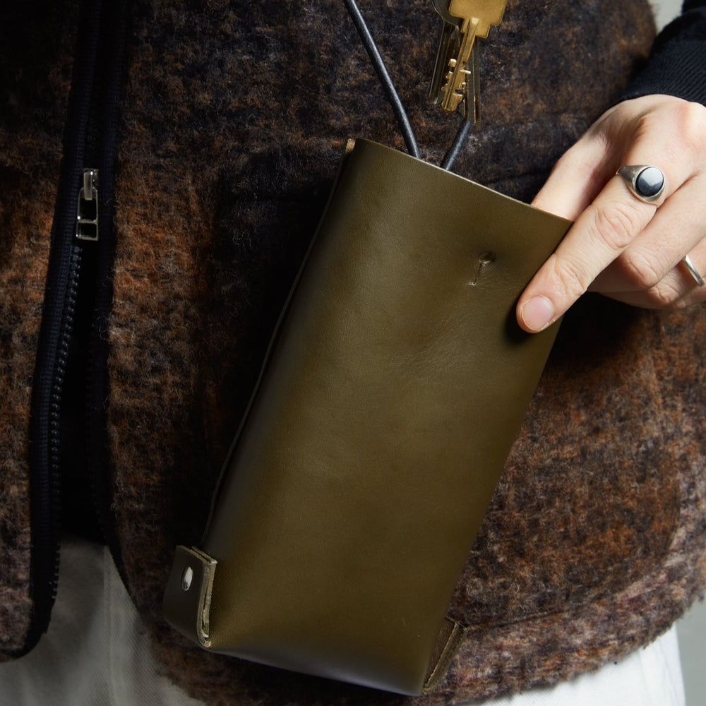 Leather Jigsaw Pouch, Olive by Earl of East x Kate Sheridan, worn over a fur coat