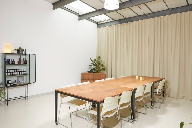 Long wooden table in a bright studio space