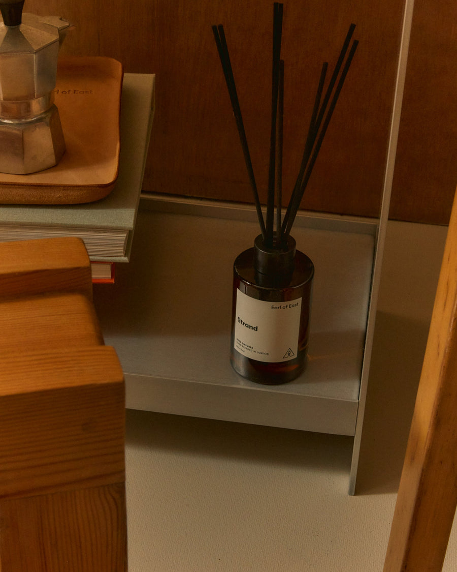 Strand Reed Diffuser, 150ml by Earl of East, on a wooden shelf