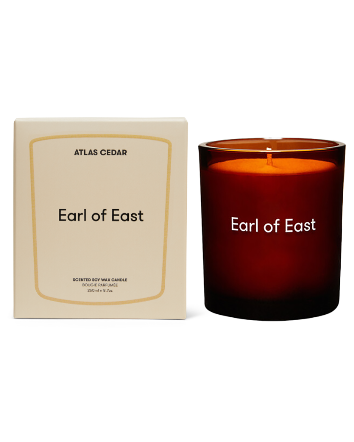 Atlas Cedar Scented Candle, 260ml by Earl of East, lit beside its box