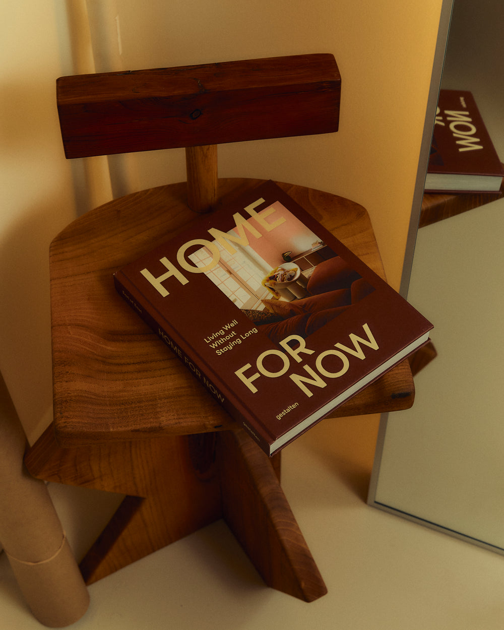 Home For Now book on a wooden stool