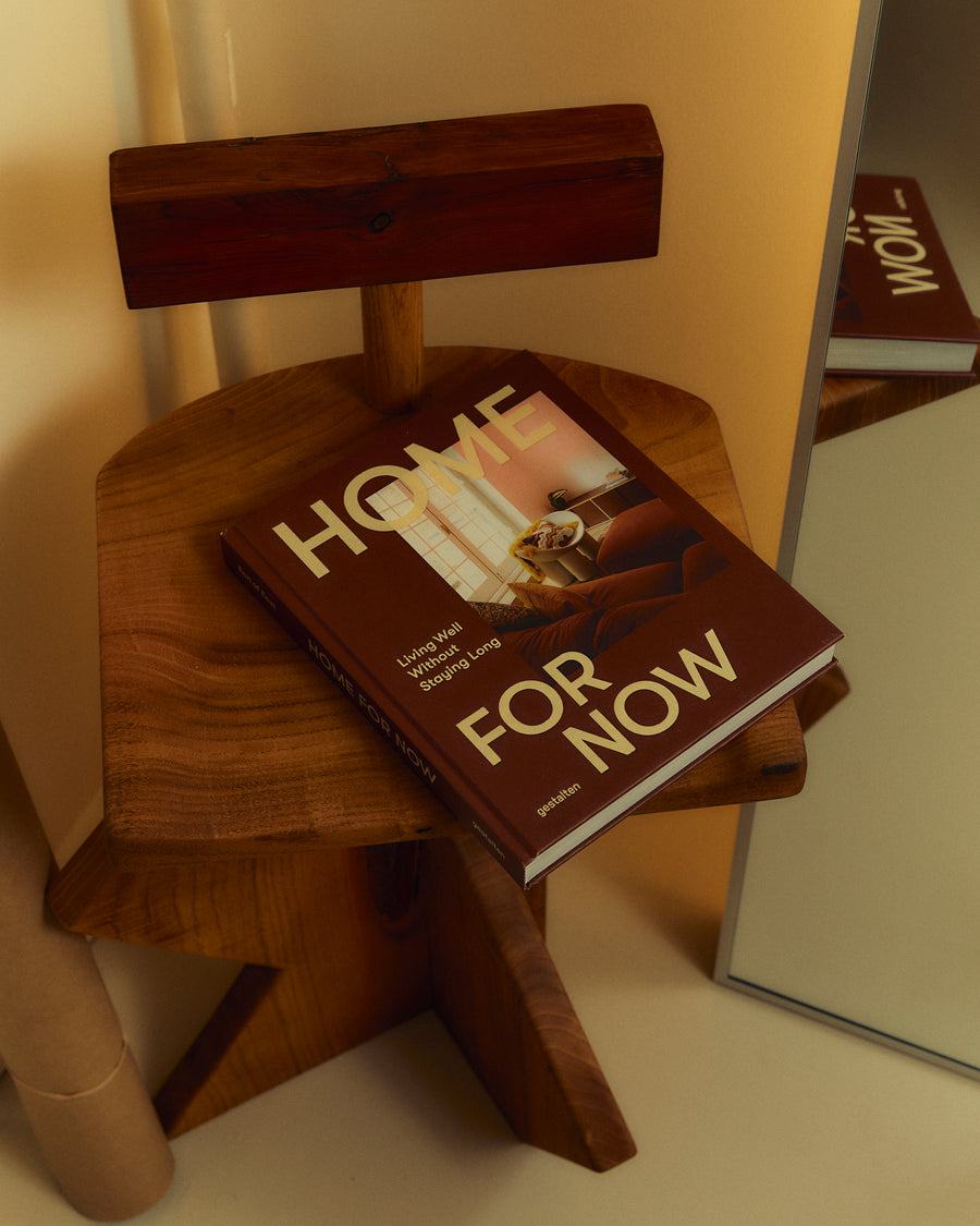Home For Now book on a wooden stool