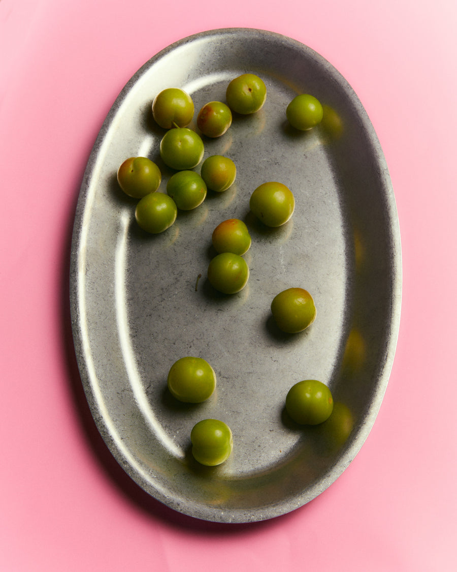 Large Oval Serving Dish, Vintage Stainless Steel by Earl of East, holding green olives on pink