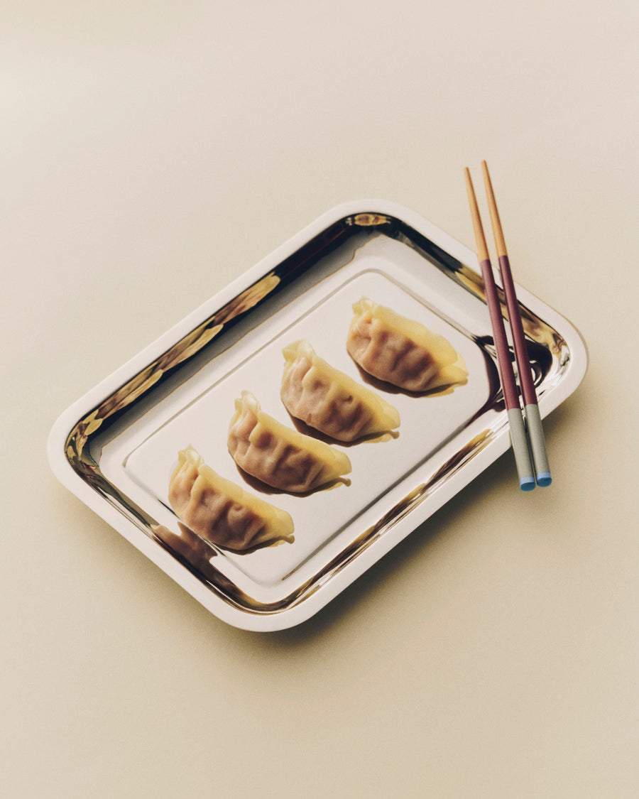 Colour Sticks Set of 4, Subtle by HAY, on a metal tray with dumplings