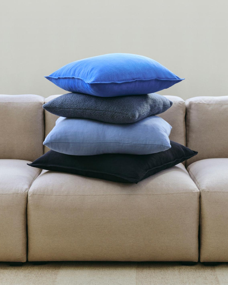 Linen Cushion, 60 x 60, Light Blue by HAY, on a grey sofa
