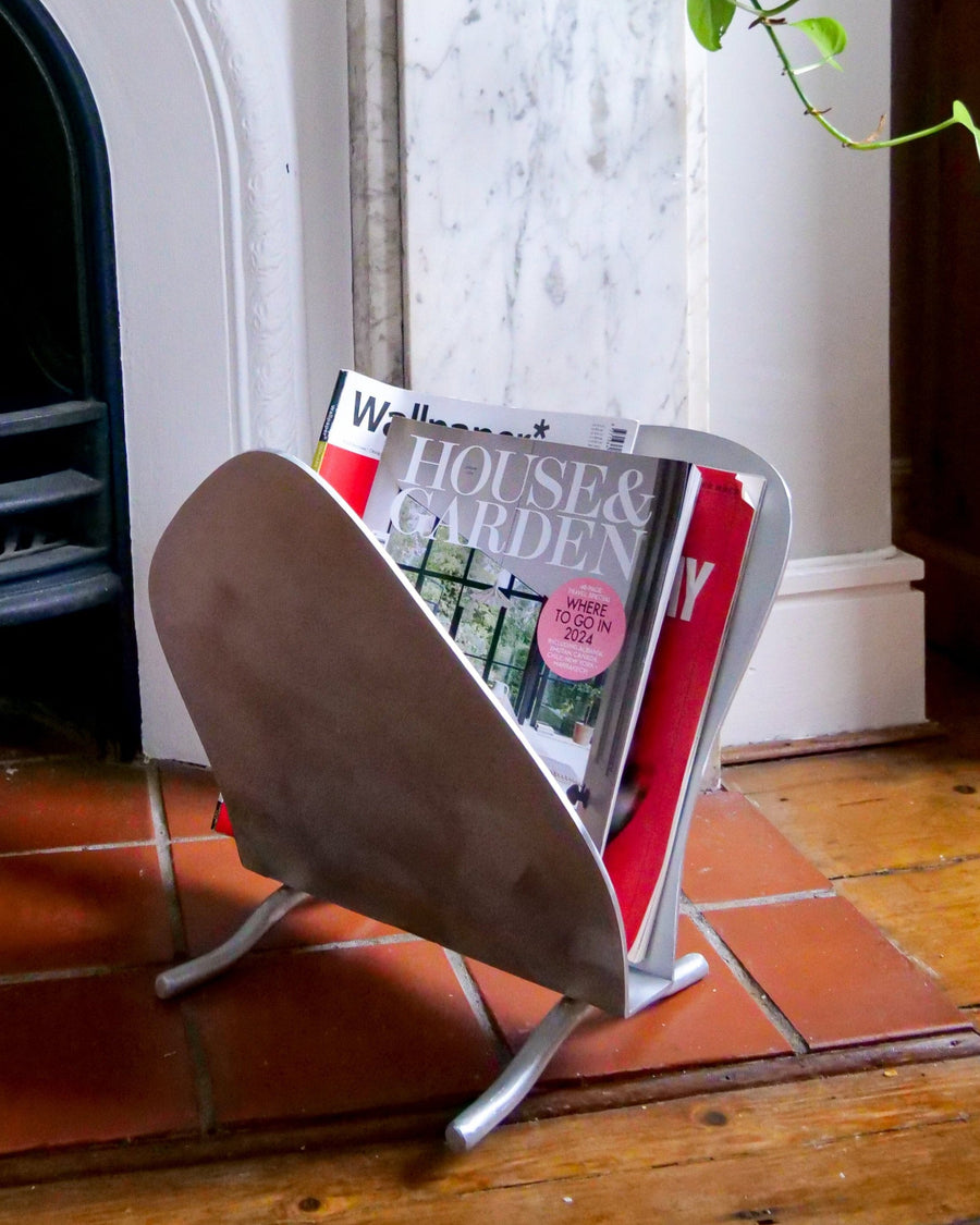 Magazine Rack, Aluminium by Six Dots Design, holding magazines in a living room
