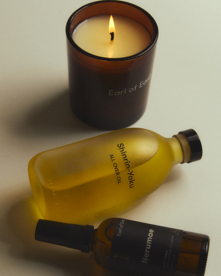 Staying In Bundle by Earl of East, candle lit beside All Over Oil
