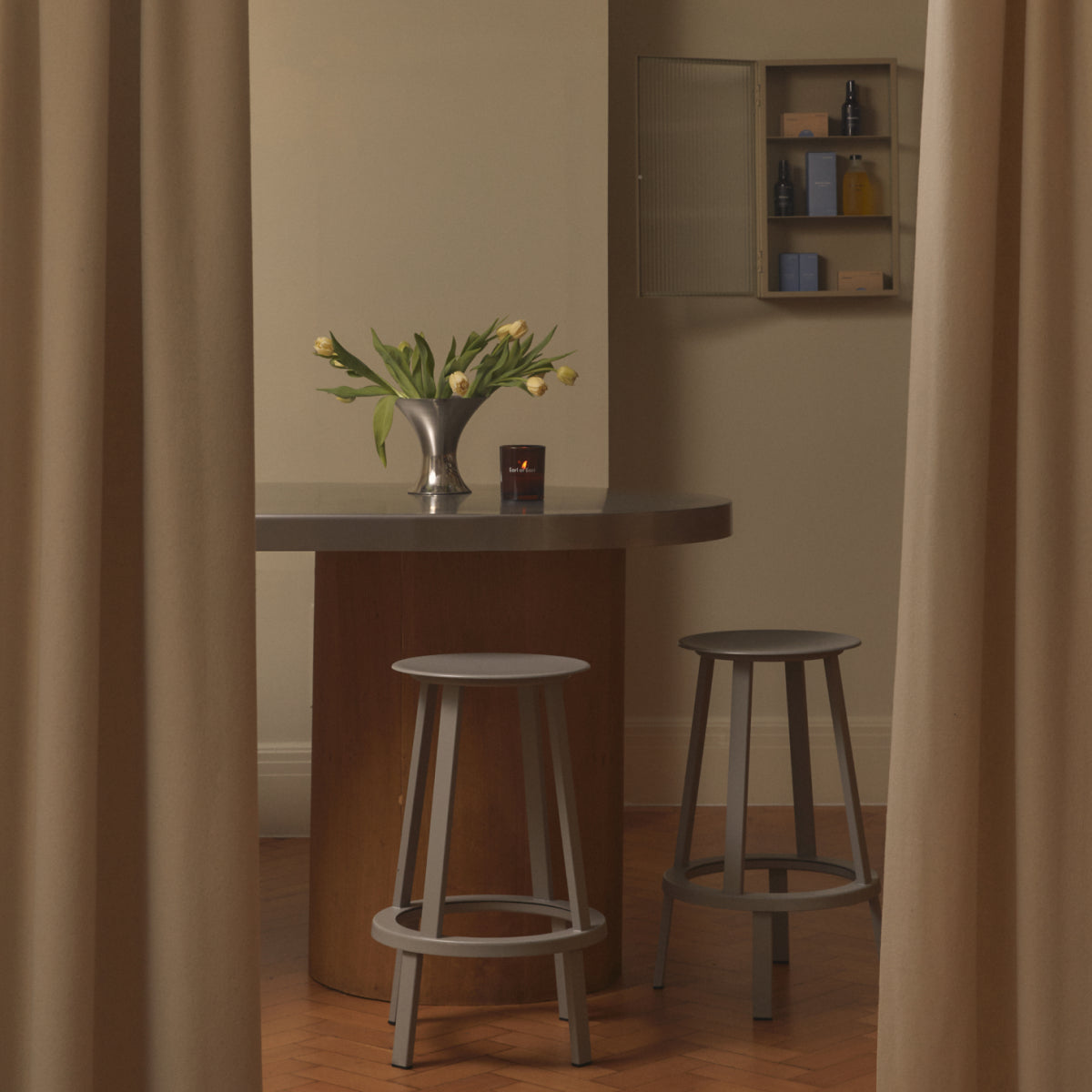 Earl of East private workshop space with a round table and stools