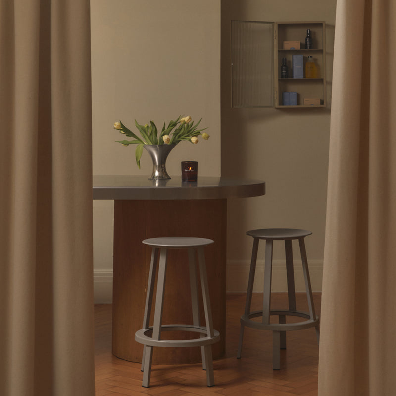 Earl of East private workshop space with a round table and stools