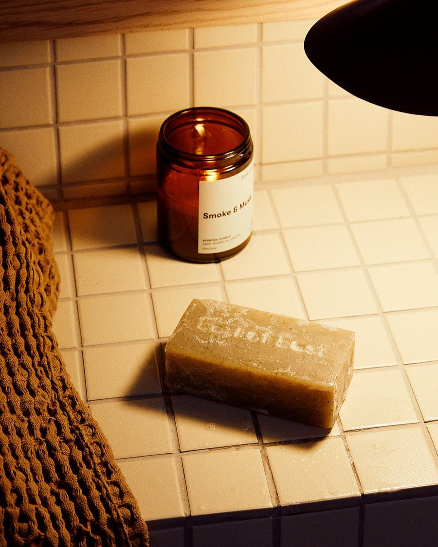 Smoke & Musk Cleansing Bar Soap, 160g by Earl of East, on a tiled surface
