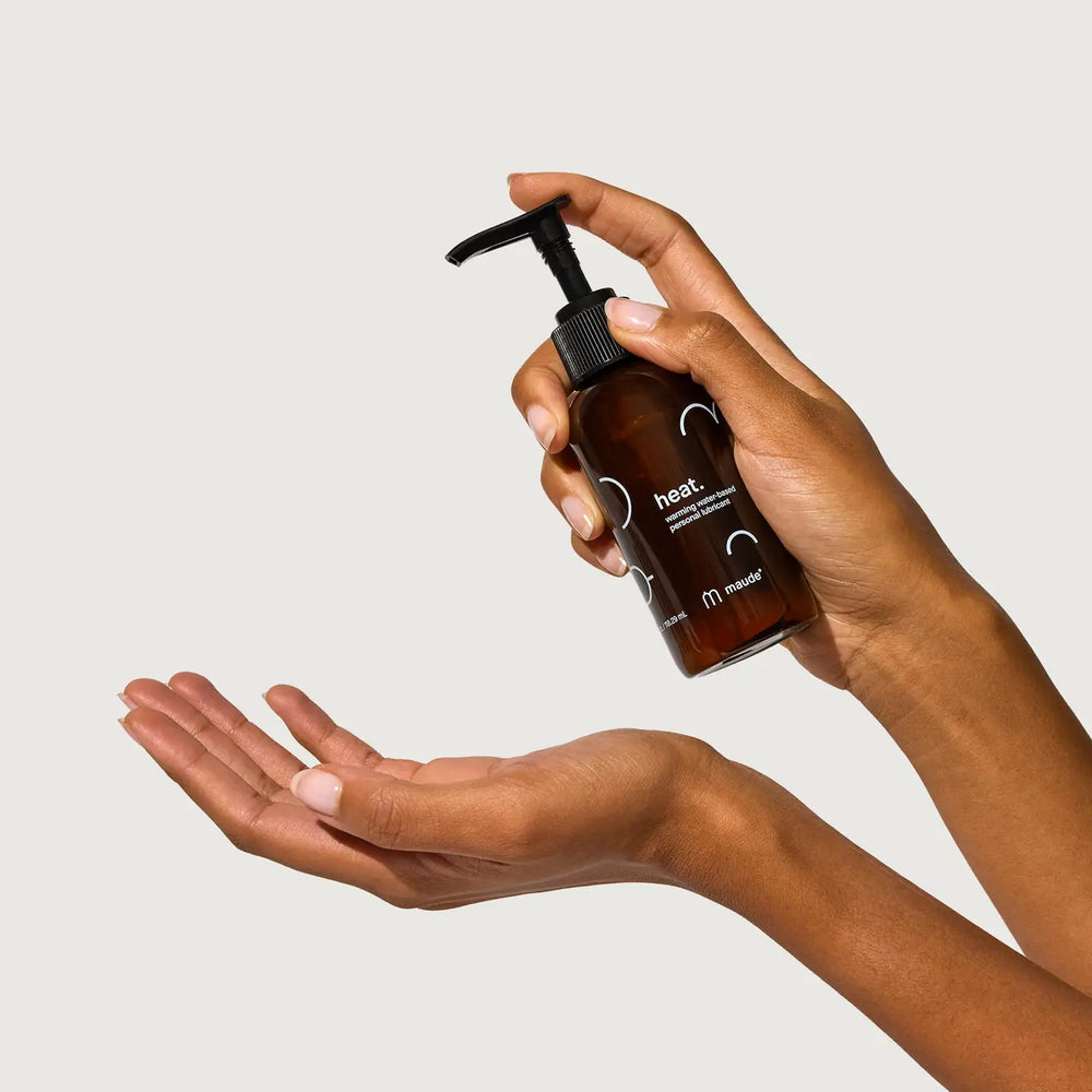 Warming Water-Based Lubricant, 4oz by Maude, being dispensed into a hand