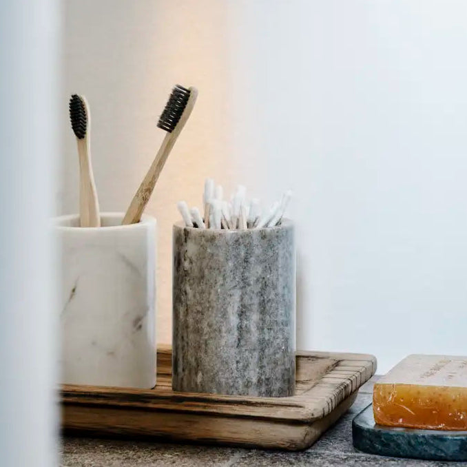 Round Marble Jar, White by Madam Stoltz, holding toothbrushes in a bathroom