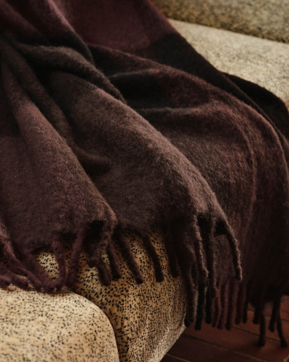 Ferm Living Blur mohair blanket draped on a chair