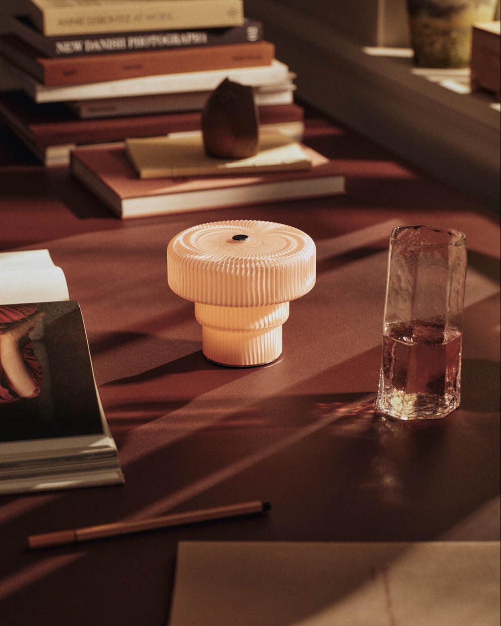 Kiru Tall Glasses, Set of 2, Clear by ferm LIVING, on a dark table with a candle