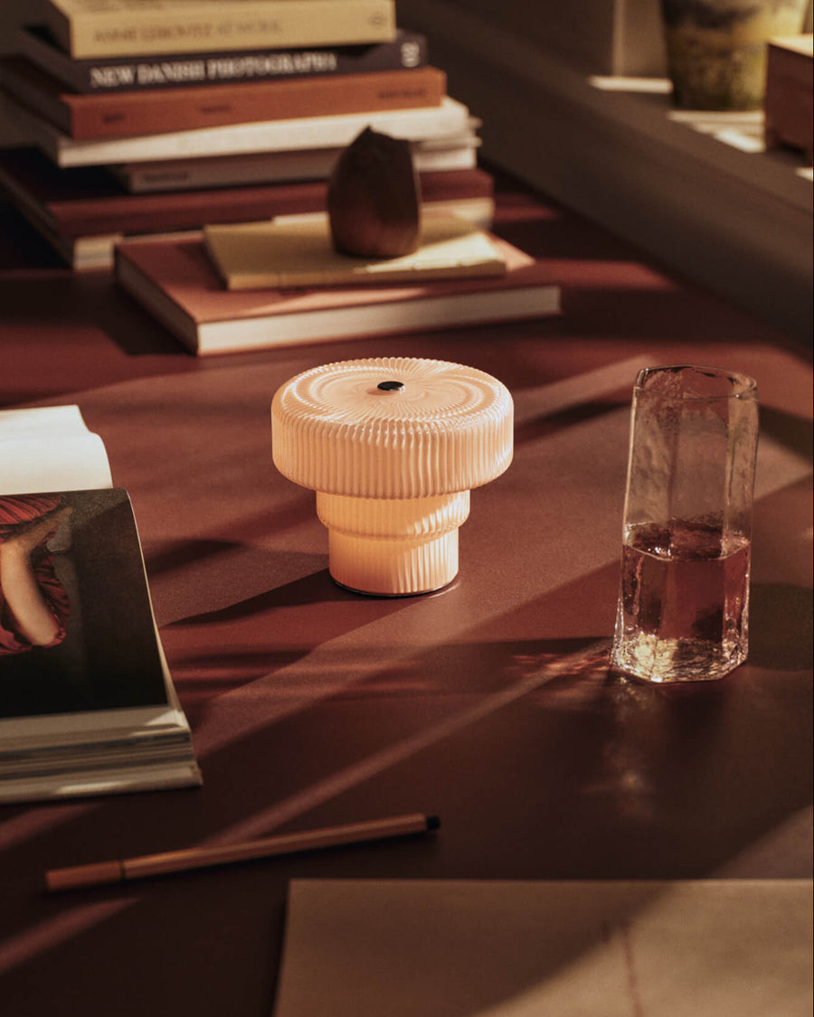 Kiru Tall Glasses, Set of 2, Clear by ferm LIVING, on a dark table with a candle