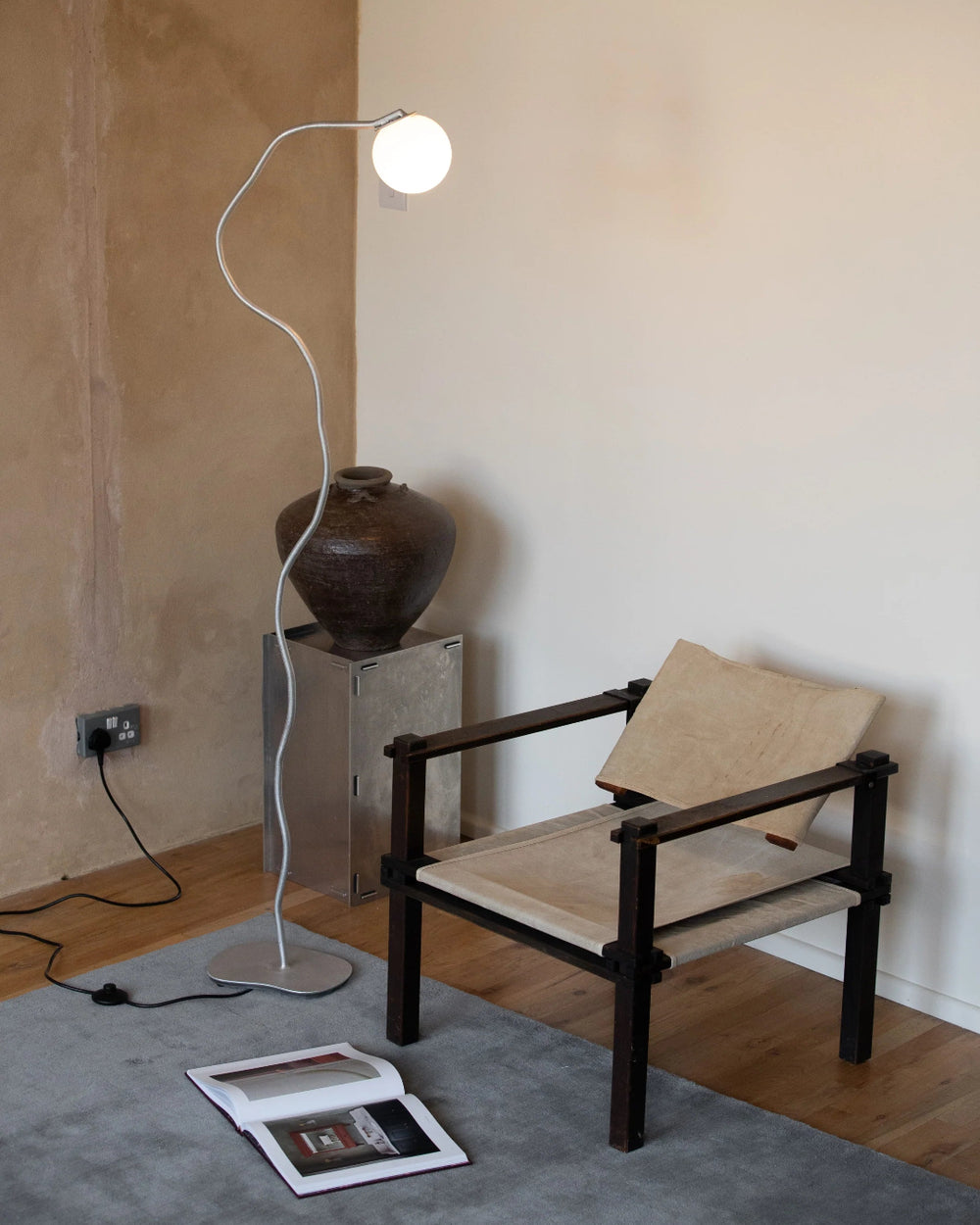 Pea Head Lamp, Aluminium by Six Dots Design, beside a chair in a room