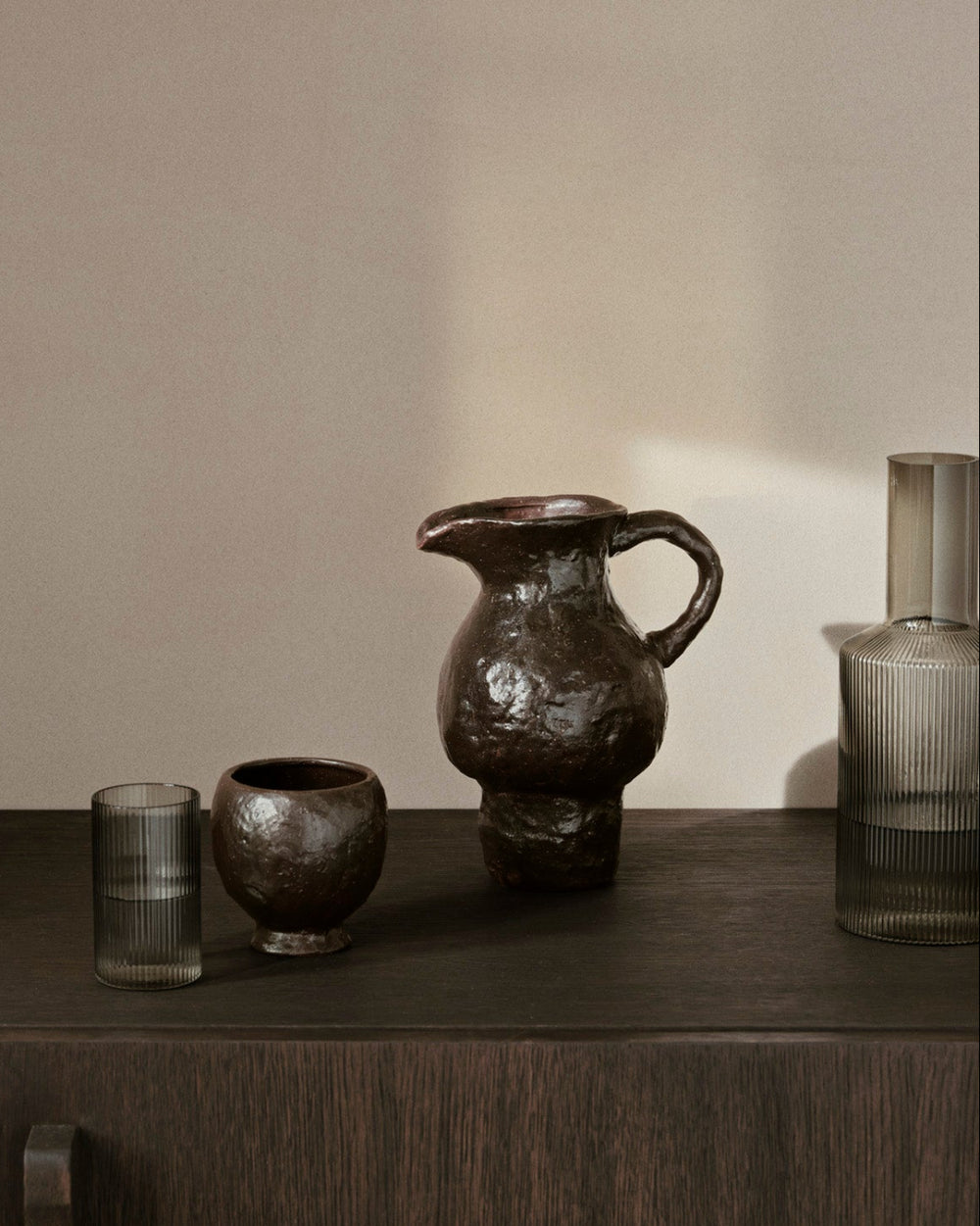 Doro Jug, Coffee by ferm LIVING, on a dark sideboard