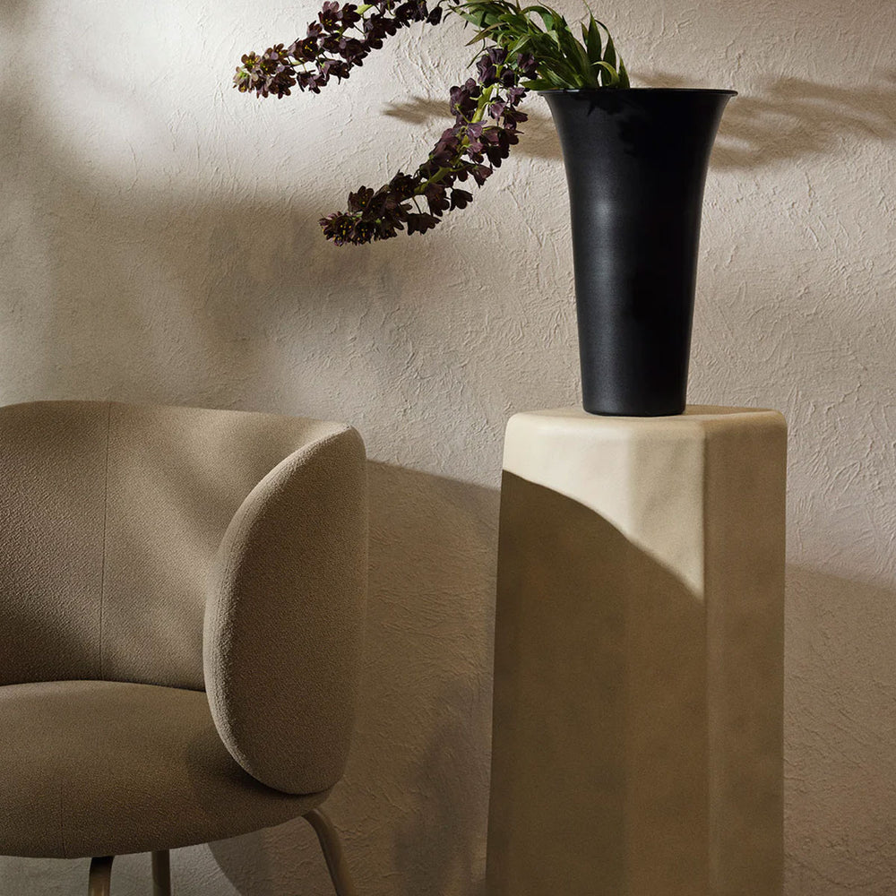 Staffa Pedestal, Ivory by ferm LIVING, holding a vase in a living room