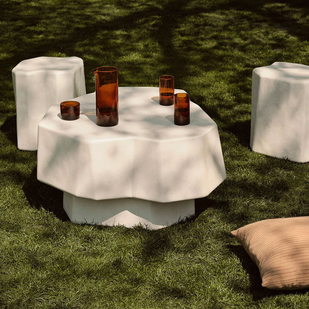 Staffa Coffee Table, Small, Ivory by ferm LIVING, set outdoors on moss