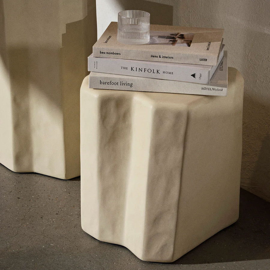 Staffa Stool, Ivory by ferm LIVING, holding books